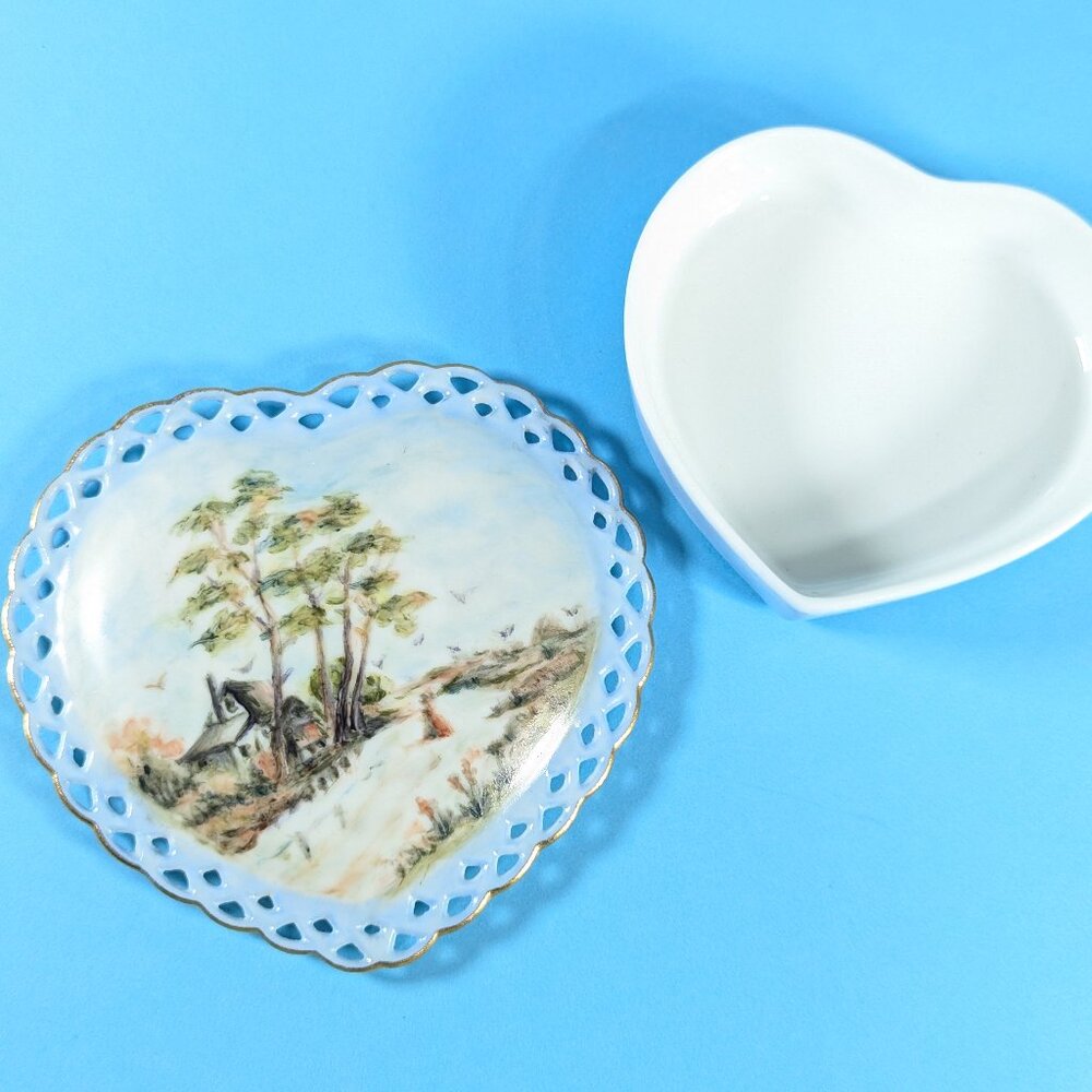 Heart shaped porcelain trinket box, hand painted pastoral scene on pierced lid